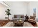 Inviting living space with vaulted ceiling, comfortable seating, and hardwood floors at 1314 Ascot Ave, Highlands Ranch, CO 80126