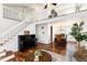 Bright living room with piano, staircase and open dining area, perfect for Gathering gatherings at 1314 Ascot Ave, Highlands Ranch, CO 80126