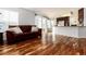 Open-concept living room with hardwood floors seamlessly flowing into an eat-in kitchen with breakfast bar at 1314 Ascot Ave, Highlands Ranch, CO 80126