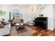 Cozy living room with bay window, stylish furniture, and a grand piano for a touch of elegance at 1314 Ascot Ave, Highlands Ranch, CO 80126
