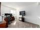 Comfortable carpeted home office featuring desk, shelving, and natural light at 1314 Ascot Ave, Highlands Ranch, CO 80126