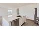 Bright kitchen features a large island with white cabinetry and stainless steel appliances at 2098 S Haleyville Way, Aurora, CO 80018