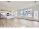 Open-concept living area and kitchen with stainless steel appliances and large island at 2098 S Haleyville Way, Aurora, CO 80018