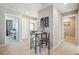 Hallway with a seating area, laundry room, and multiple doorways at 6531 14Th St, Frederick, CO 80530