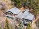 Expansive log cabin home with multiple decks, surrounded by lush forest and beautiful mountain scenery at 39 Pat Creek Rd, Evergreen, CO 80439