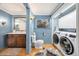 Well-lit bathroom with wood floors, elegant vanity and convenient washer and dryer at 39 Pat Creek Rd, Evergreen, CO 80439