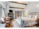 Beautiful bedroom featuring a fireplace, French doors, hardwood floors, and a large window at 39 Pat Creek Rd, Evergreen, CO 80439