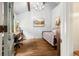 Comfortable bedroom area with wood floors, desk, art, and a comfortable bed at 39 Pat Creek Rd, Evergreen, CO 80439
