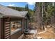 Charming log cabin showcasing a cozy porch with seating and beautiful wood accents at 39 Pat Creek Rd, Evergreen, CO 80439