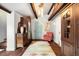 Inviting foyer with hardwood floors, colorful rug, antique furniture, and charming blue entry door at 39 Pat Creek Rd, Evergreen, CO 80439