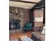 Stone fireplace with log walls and wood accents create a rustic, cozy ambiance in this living area at 39 Pat Creek Rd, Evergreen, CO 80439