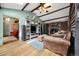 Inviting living room features exposed wood beams, a stone fireplace, and rustic details at 39 Pat Creek Rd, Evergreen, CO 80439