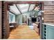 Spacious living room offers rustic charm, wood beam ceilings, and a seamless flow into dining space at 39 Pat Creek Rd, Evergreen, CO 80439