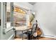 Sunlit office space with stained glass window, guitar, and banjo at 39 Pat Creek Rd, Evergreen, CO 80439