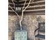 Cozy outdoor space with stone wall, custom light fixture, decorative stools, and wrought iron bench seating at 39 Pat Creek Rd, Evergreen, CO 80439