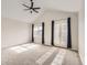 Bright bedroom featuring a vaulted ceiling, ceiling fan, natural light, and double doors leading to an outdoor area at 9813 E Carolina Pl, Aurora, CO 80247