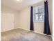 This bedroom has neutral walls, a large window, and a double door closet at 9813 E Carolina Pl, Aurora, CO 80247