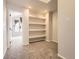 Versatile bonus room with built-in shelving and an adjacent room, ideal for a home office or play area at 9813 E Carolina Pl, Aurora, CO 80247
