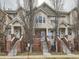 Inviting townhome with a well-maintained exterior, including a brick facade and landscaped entrance at 9813 E Carolina Pl, Aurora, CO 80247