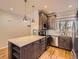 Spacious kitchen with a functional island, pendant lighting, and stainless steel appliances at 9813 E Carolina Pl, Aurora, CO 80247