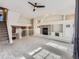 Open-concept living area with a decorative fireplace, recessed lighting, and a ceiling fan at 9813 E Carolina Pl, Aurora, CO 80247