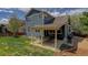 Backyard with patio and well-maintained lawn at 9996 Sedalia St, Commerce City, CO 80022