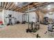 Spacious unfinished basement area designed as a home gym with workout equipment at 9996 Sedalia St, Commerce City, CO 80022