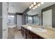 The bathroom has a double sink vanity, soaking tub, and walk-in shower at 9996 Sedalia St, Commerce City, CO 80022
