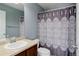 Bathroom featuring shower with a patterned curtain, vanity and sink at 9996 Sedalia St, Commerce City, CO 80022
