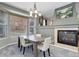 Cozy dining area featuring a fireplace and picturesque window views at 9996 Sedalia St, Commerce City, CO 80022