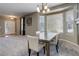 Elegant dining area with a bay window, stylish chandelier, and comfortable seating at 9996 Sedalia St, Commerce City, CO 80022