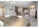 Open dining and living area with wooden staircase and neutral gray walls at 9996 Sedalia St, Commerce City, CO 80022