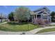 Well-manicured lawn and landscaping surround this beautiful two-story home on a sunny corner lot at 9996 Sedalia St, Commerce City, CO 80022