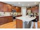 A full view of the kitchen showing stainless steel appliances and a breakfast bar at 9996 Sedalia St, Commerce City, CO 80022