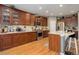 Spacious kitchen featuring dark cabinets, a center island, and stainless steel appliances at 9996 Sedalia St, Commerce City, CO 80022