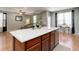 The bright kitchen island opens up to the living room and breakfast nook at 9996 Sedalia St, Commerce City, CO 80022