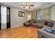 Spacious living room with hardwood floors, lots of seating, and natural light at 9996 Sedalia St, Commerce City, CO 80022