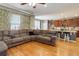 Open-concept living room and kitchen featuring hardwood floors and ample seating at 9996 Sedalia St, Commerce City, CO 80022