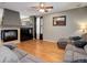 A view of the living room with a fireplace, and large comfy couches at 9996 Sedalia St, Commerce City, CO 80022