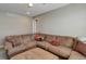 Living room with sectional couch and a neutral color palette at 9996 Sedalia St, Commerce City, CO 80022