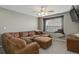 Comfortable living room features a sectional couch, ottoman, and a window nook at 9996 Sedalia St, Commerce City, CO 80022