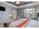 Large main bedroom with high ceilings and bathroom access through a sliding barn door at 9996 Sedalia St, Commerce City, CO 80022