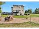 Backyard showcasing a patio, deck, and a spacious lawn with mature trees at 36545 Winchester Rd, Elizabeth, CO 80107