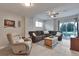 Cozy basement living area featuring plush seating, a ceiling fan, and access to the backyard at 36545 Winchester Rd, Elizabeth, CO 80107