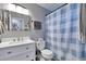 Bathroom featuring a vanity and shower with blue-and-white checkered curtain at 36545 Winchester Rd, Elizabeth, CO 80107