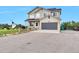 Charming two-story home featuring a well-maintained front yard and an attached two-car garage at 36545 Winchester Rd, Elizabeth, CO 80107