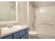 Bright bathroom featuring a clean white tiled shower-tub and blue vanity at 10035 E Carolina Pl # 201, Aurora, CO 80247