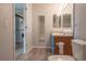 Bathroom boasts a vanity with a blue cabinet, a toilet, and a stacked washer and dryer at 10035 E Carolina Pl # 201, Aurora, CO 80247