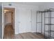 Bedroom featuring a closet with sliding doors, neutral paint and wood-look flooring at 10035 E Carolina Pl # 201, Aurora, CO 80247