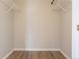 Empty closet with wooden floors and hanging rack at 10035 E Carolina Pl # 201, Aurora, CO 80247